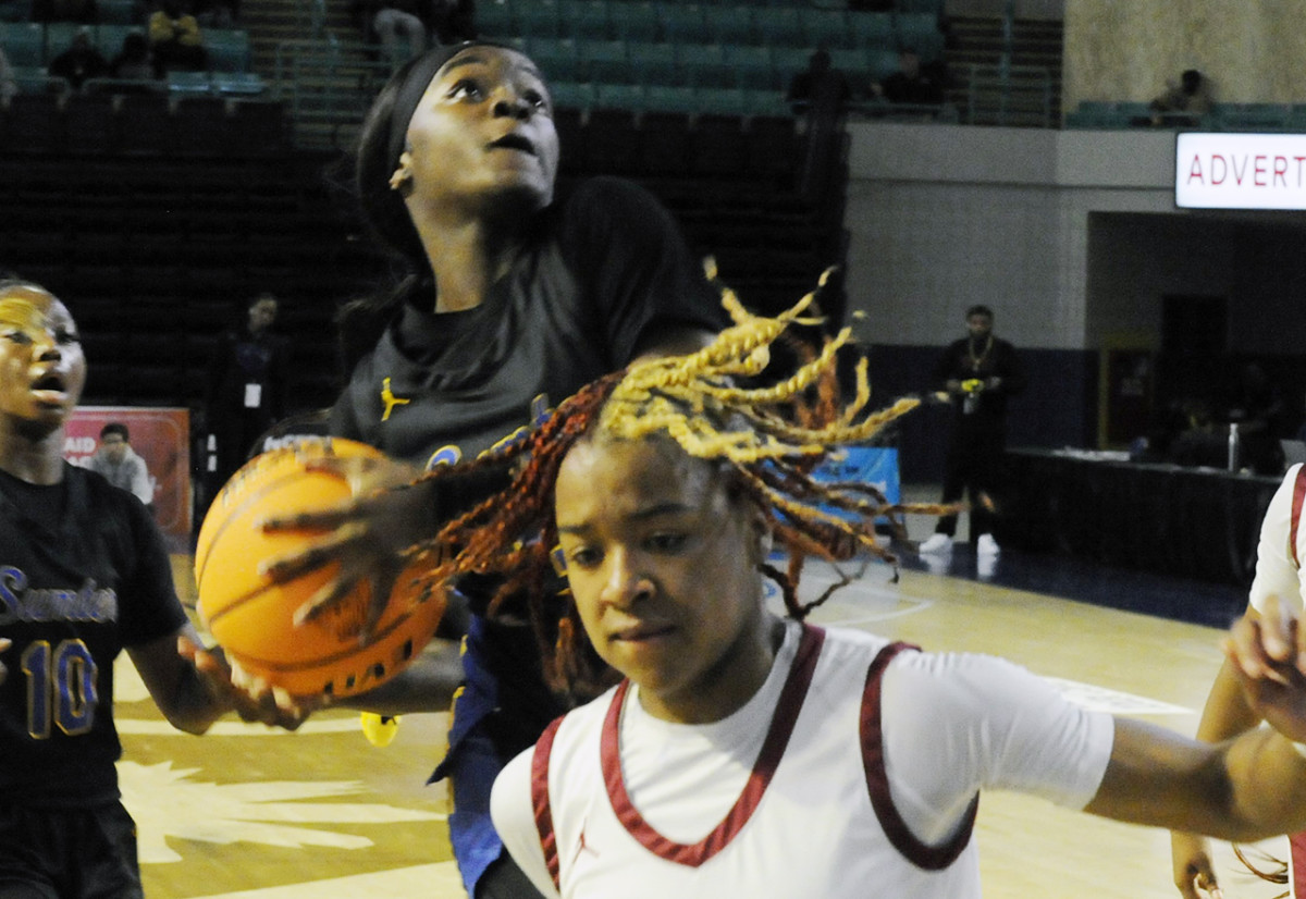 Sumter guard Kiara Croskey drives in behind Rock Hill's Omadeah Ford (20) for two points in the 2024 SCHSL Class 5-A Girls Basketball State Championship Game. (3/1/2024)